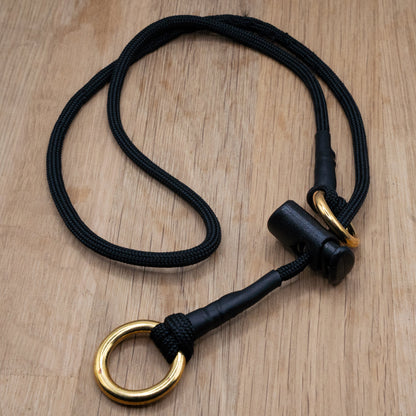 Black paracord Slip Collar with Solid brass 'O' rings and a cord stopper
