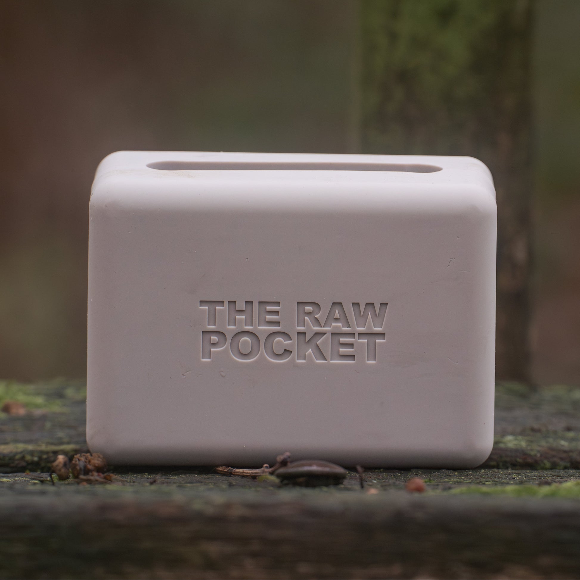 Stone coloured The Raw Pocket a silicone dog training pouch sat on a bench